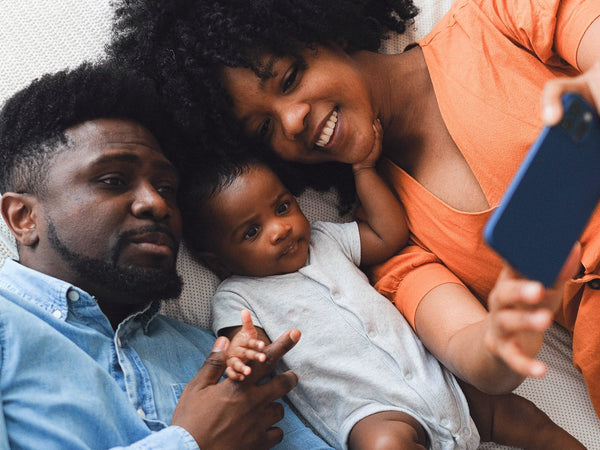 Parents taking selfie with baby