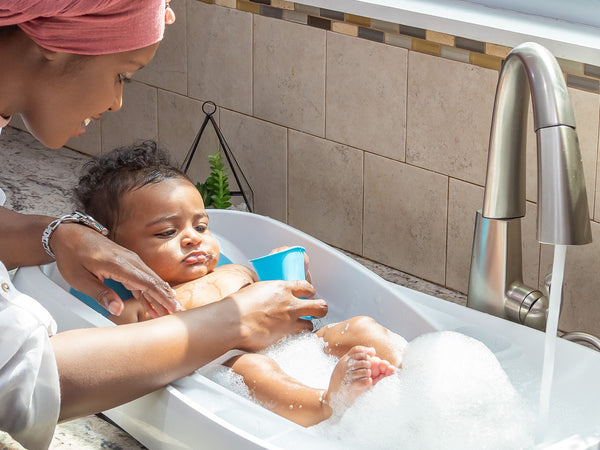 Mom bathing baby in Cleanwater Tub