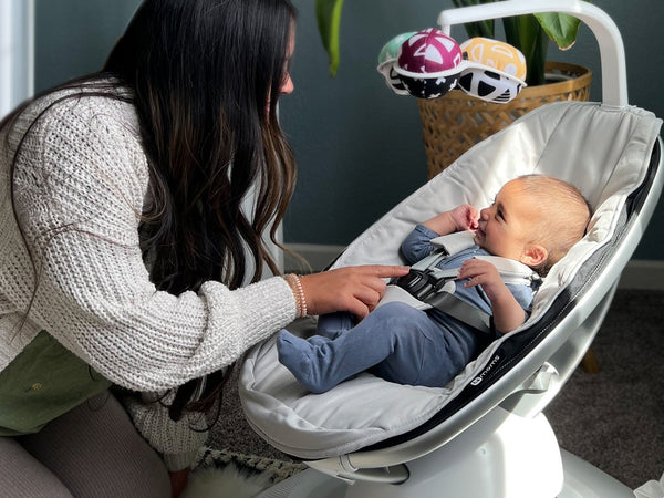 Baby in 4moms MamaRoo Multi-Motion Baby Swing