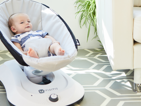 Baby sitting in MamaRoo Baby Swing in living room