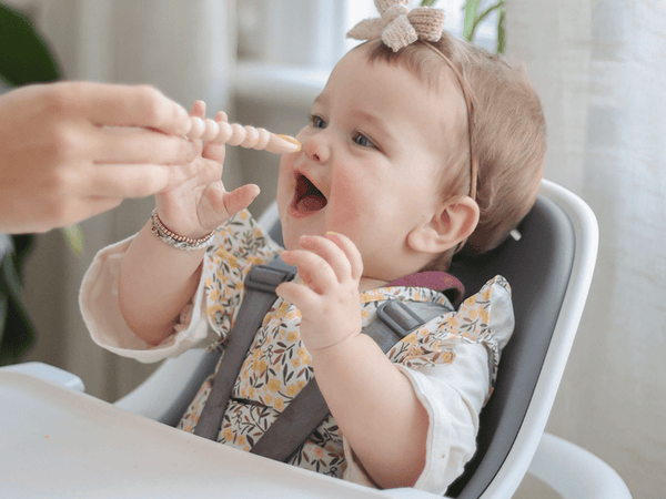 Baby eating in 4moms Connect High Chair