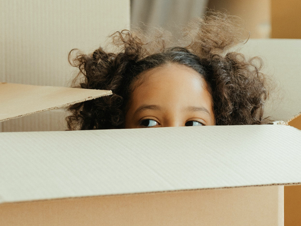 Kid hiding in cardboard box