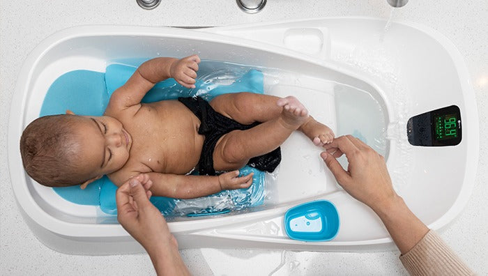 a baby in a baby bath